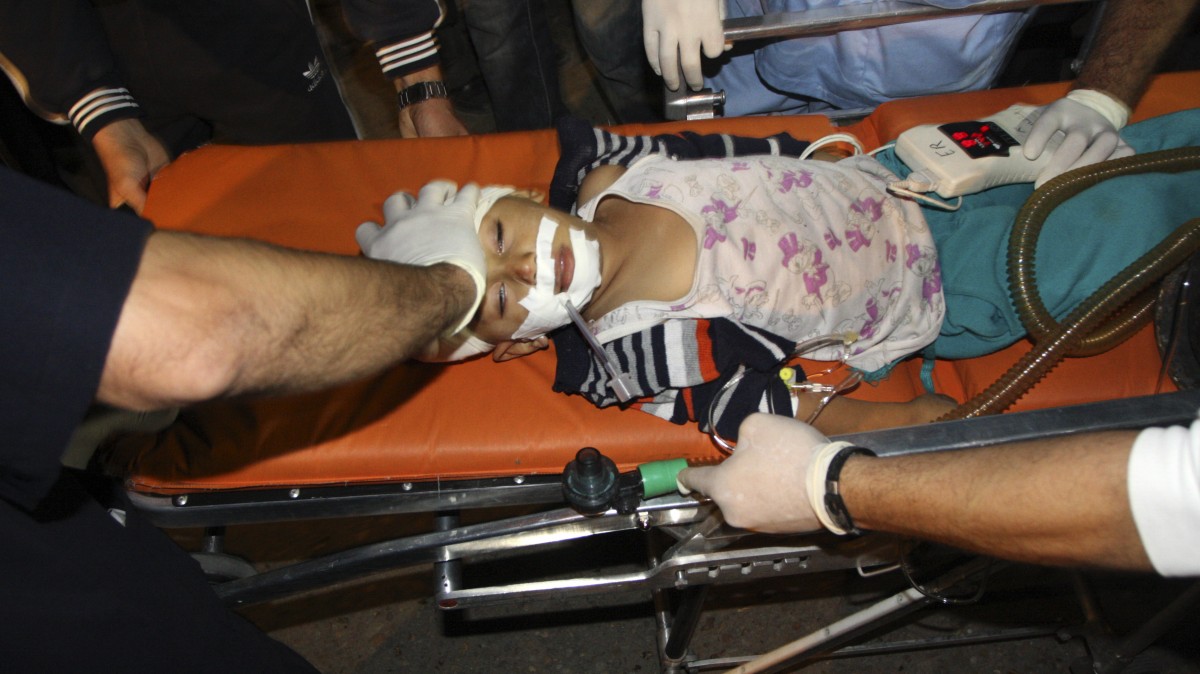 Palestinian medics wheel a wounded child into the treatment room of Shifa hospital following an Israeli airstrike in Gaza City, Wednesday, Nov. 14, 2012. (AP Photo/Majed Hamdan)
