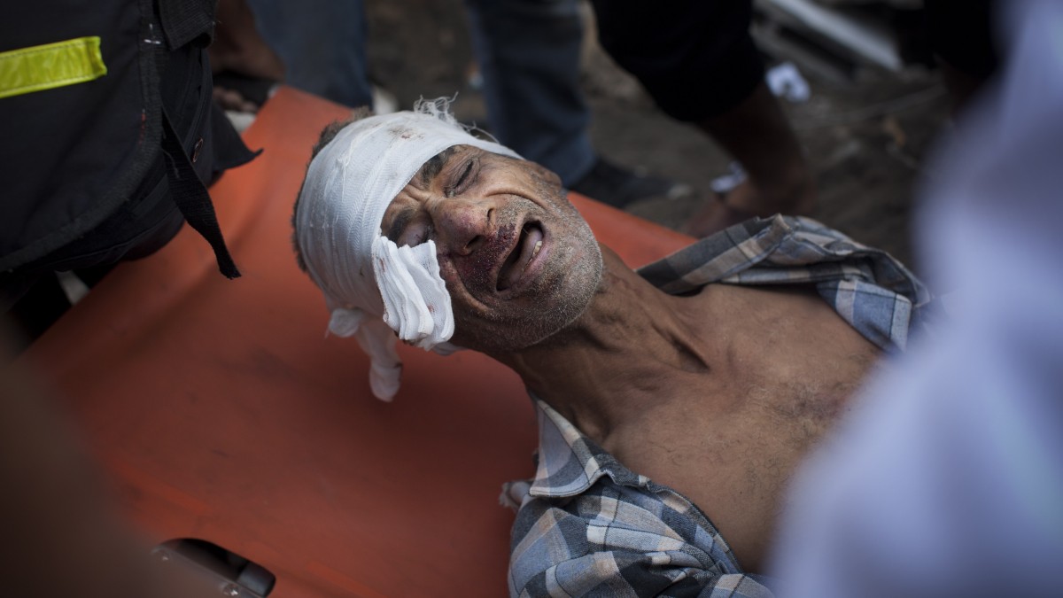 A member of the Abdel Aal family is rescued after his family house collapsed during an Israeli forces strike in the Tufah neighborhood, Gaza City, Sunday, Nov. 18, 2012. (AP Photo/Bernat Armangue)