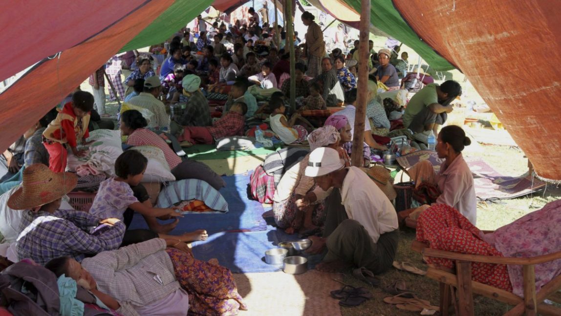 Myanmar earthquake victims take refugee under temporary shelter after their residence was damaged by a strong earthquake, Monday, Nov.12, 2012, in Kyaukmyaung township, Shwebo, Sagaing Division, northwest of Mandalay, Myanmar. (AP Photo/Khin Maung Win)