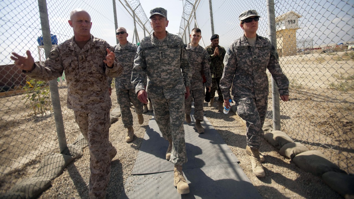 In this Sept. 27, 2010 file photo reviewed by the U.S. military, Gen. David Petraeus, center, tours the grounds of the U.S. run Parwan detention facility near Bagram north of Kabul, Afghanistan. (AP Photo/David Guttenfelder)
