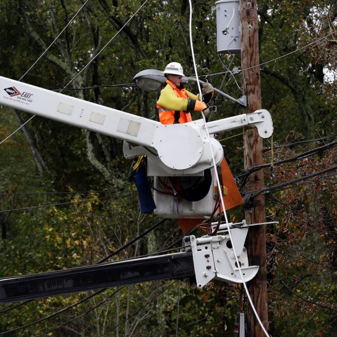 This photo taken Oct. 30, 2012, shows a utility crew working on damaged power lines in the aftermath of superstorm Sandy in Berlin, Md. (AP Photo/Alex Brandon)