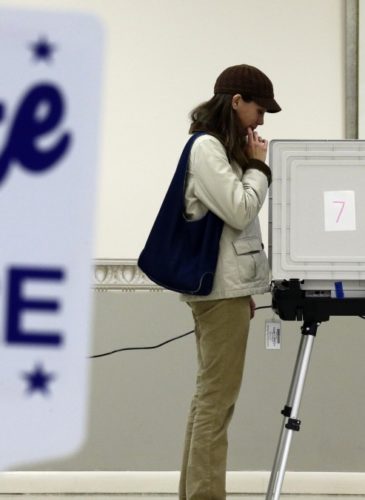 Kimberly Fisher, from White Haven, Md., casts her ballot at a polling place at the Wicomico County Youth and Civic Center in Salisbury, Md., Wednesday, Oct. 31, 2012, after superstorm Sandy passed through the area. (AP Photo/Alex Brandon)