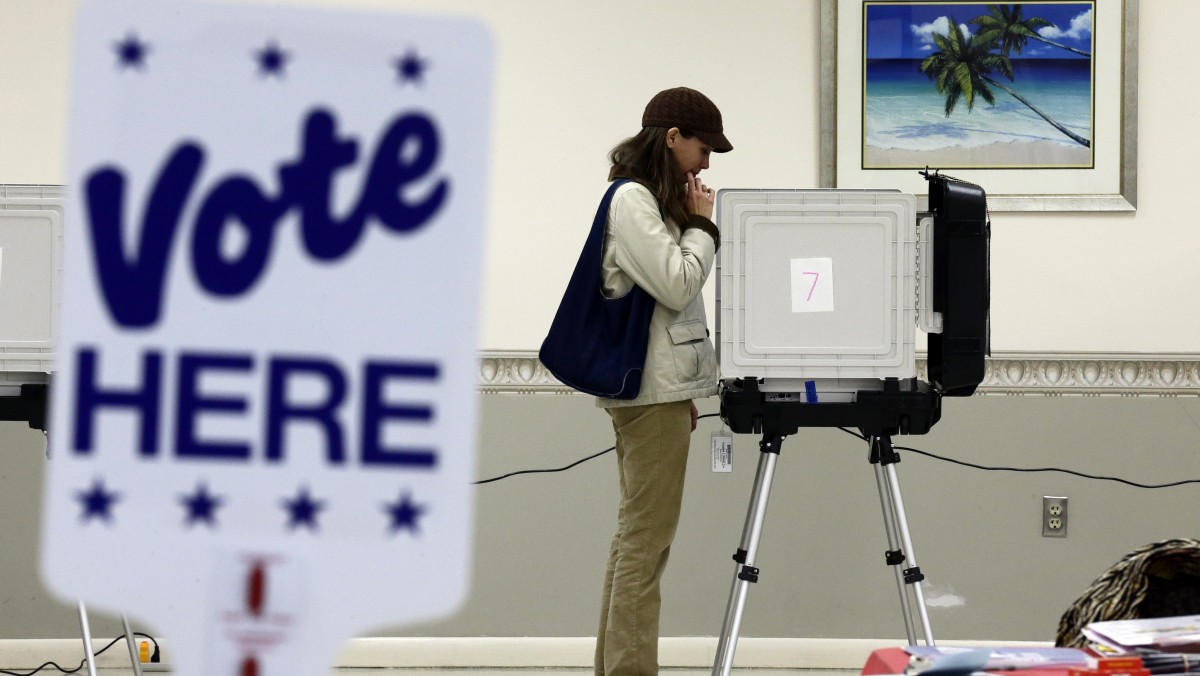 Kimberly Fisher, from White Haven, Md., casts her ballot at a polling place at the Wicomico County Youth and Civic Center in Salisbury, Md., Wednesday, Oct. 31, 2012, after superstorm Sandy passed through the area. (AP Photo/Alex Brandon)