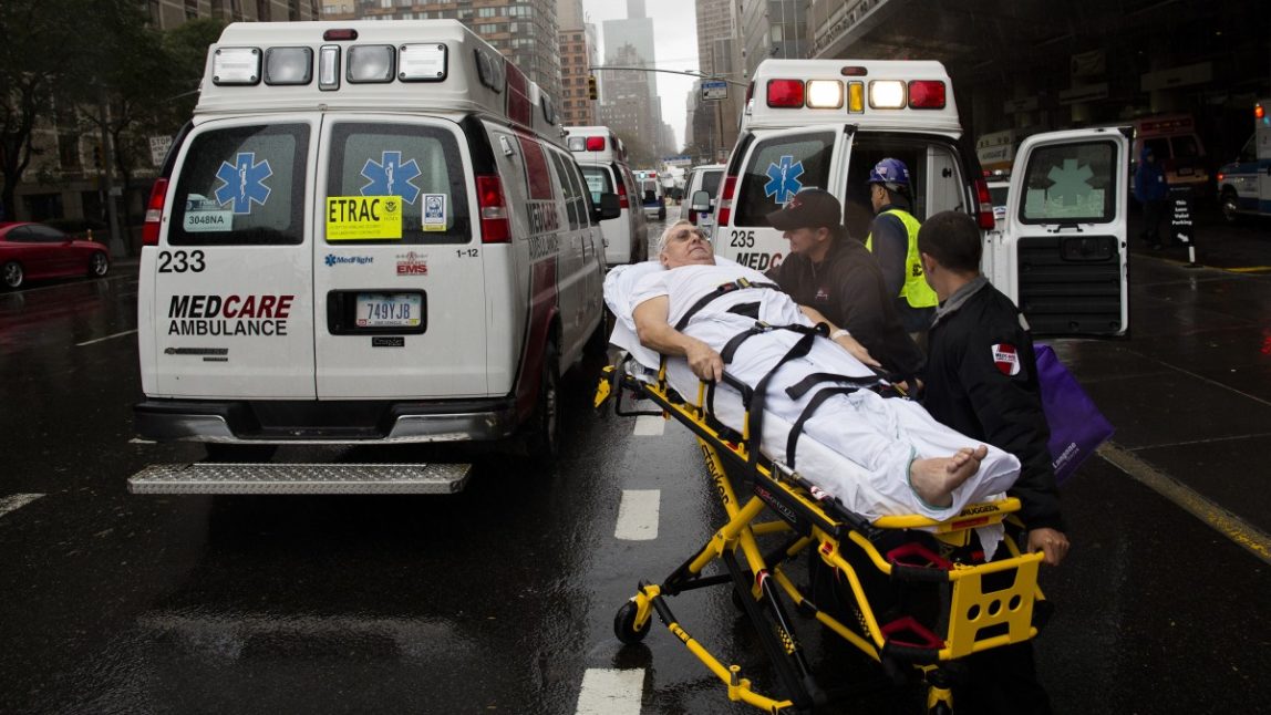 A patient is wheeled to an ambulance in the rain during an evacuation of New York University Tisch Medical, Tuesday, Oct. 30, 2012, in New York. (AP Photo/ John Minchillo)