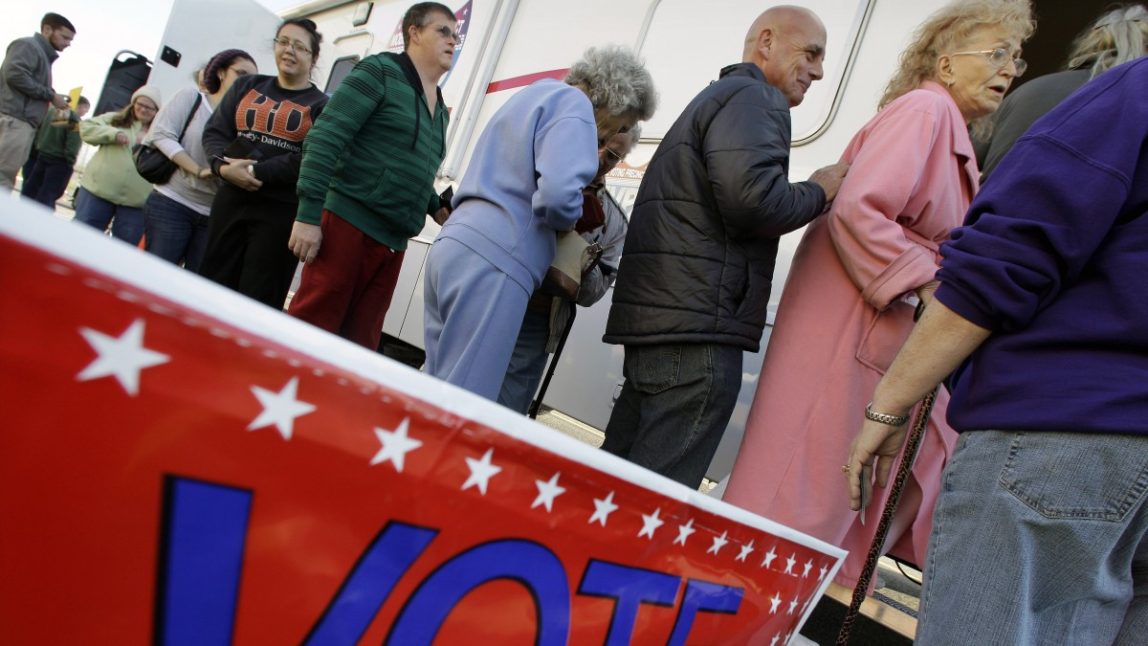 Dorothy Ann Van, of Surf City, Long Beach Island, N.J., who was displaced by Superstorm Sandy, stands at the front of a line to vote Monday, Nov. 5, 2012, in Burlington, N.J., at a Mobile Voting Precinct. (AP Photo/Mel Evans)