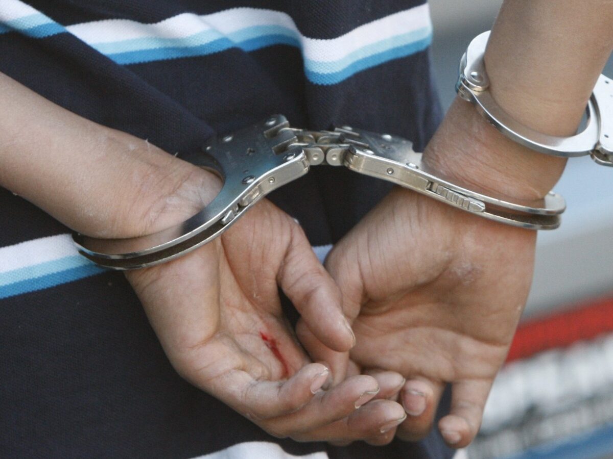 In this April 11, 2010 photo, people are handcuffed in Detroit. (AP Photo/Carlos Osorio)