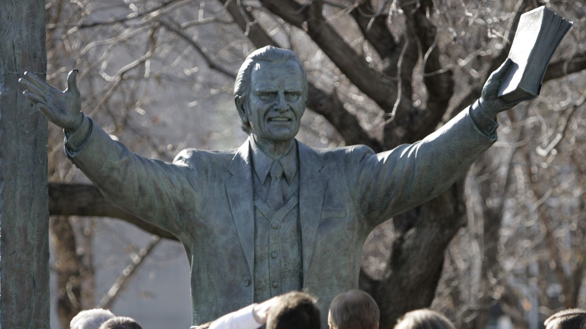 A bronze statue of evangelist Billy Graham towers above a crowd gathered to see its unveiling in Nashville, Tenn., Wednesday, Dec. 13, 2006. (AP Photo/Mark Humphrey)