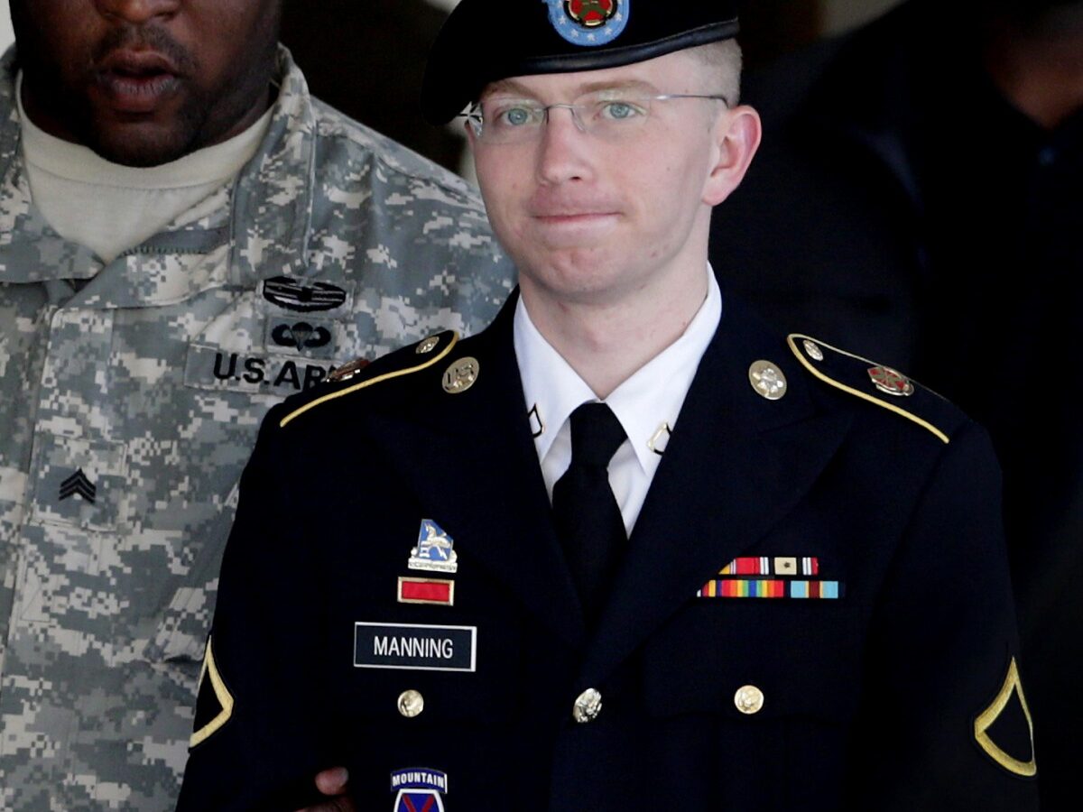 In this June 25, 2012 file photo, Army Pfc. Bradley Manning, right, is escorted out of a courthouse in Fort Meade, Md. (AP Photo/Patrick Semansky, File)