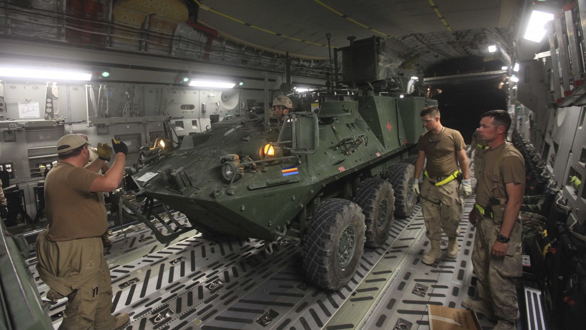 In this Saturday, July 16, 2011 file photo a Canadian armoured vehicle is loaded in a C-17 military transport aircraft at Kandahar airbase in Afghanistan. (AP Photo/Rafiq Maqbool/file)