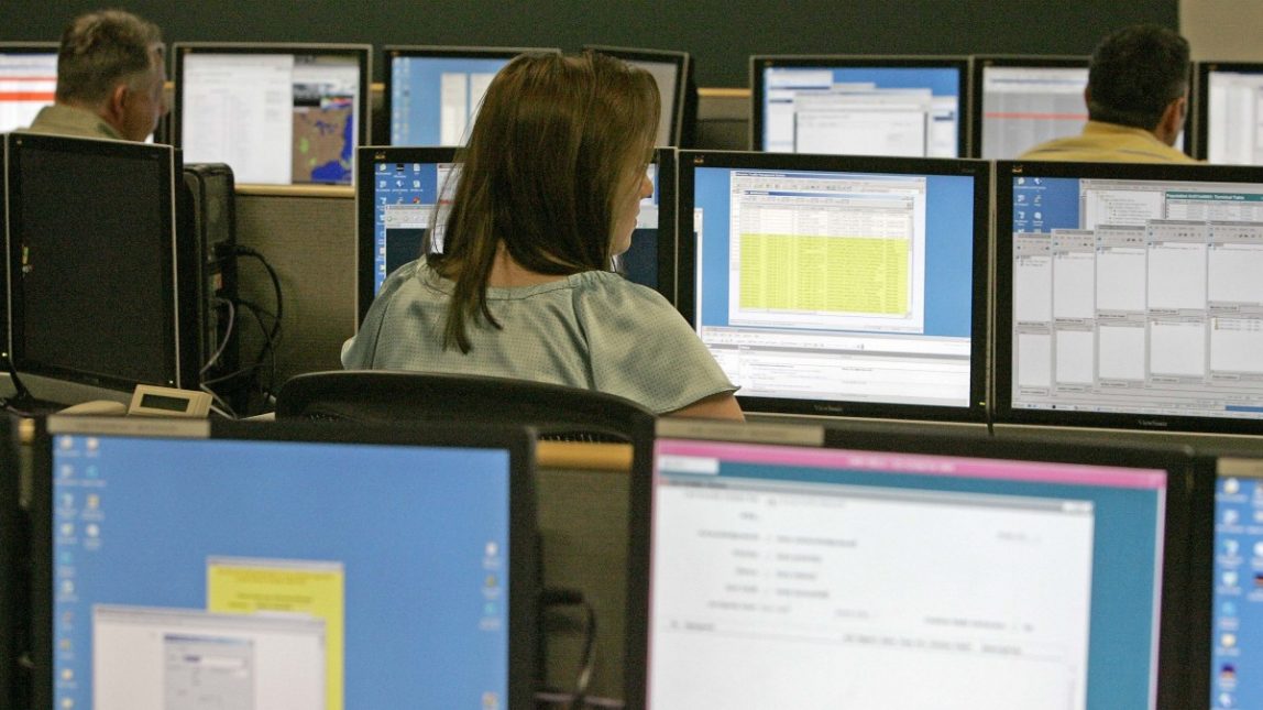 In this June 19, 2008 file photo, Verizon employees monitor activity in the Very Small Aperture Terminal Network Management Center, called VSAP, at the Verizon Business Managed Services Center in Cary, N.C. (AP Photo/Gerry Broome, File)