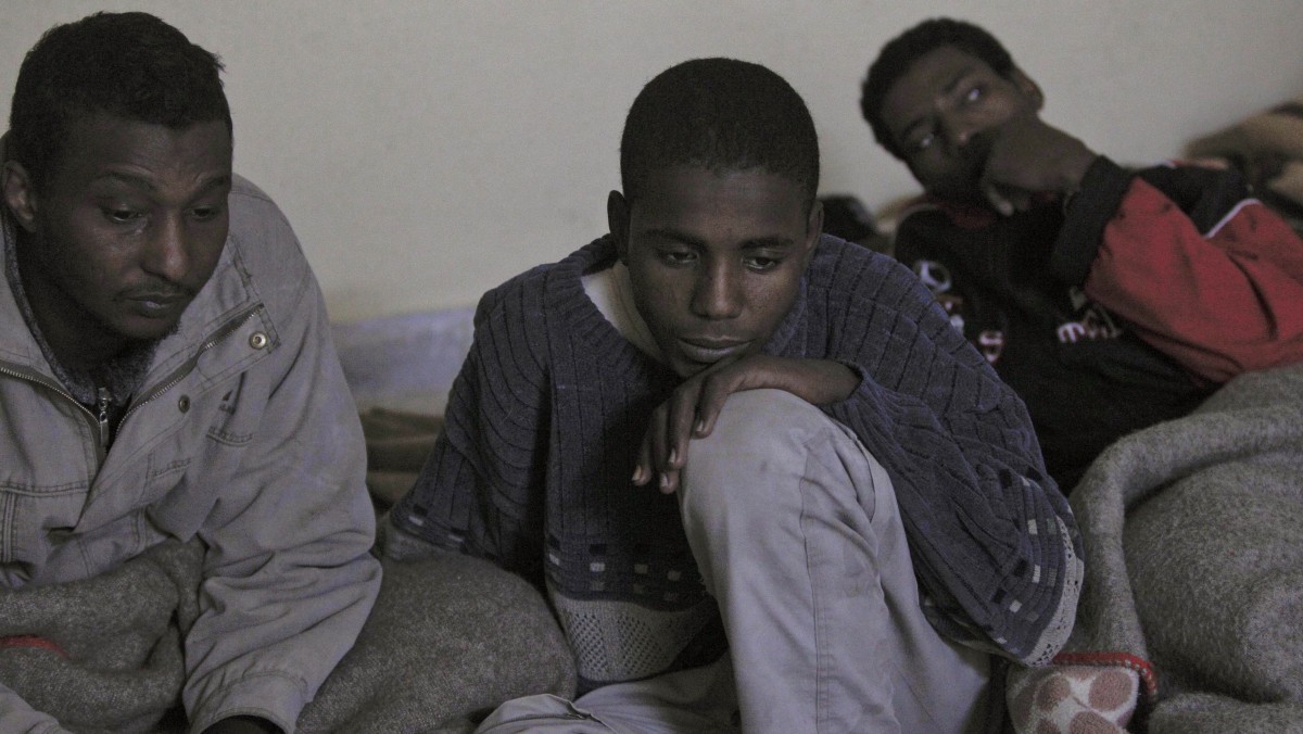 Men sit on mattresses in a make-shift detention center in a school inside the eastern town of Shahat, Libya, Friday, Feb. 25, 2011. (AP Photo/Tara Todras-Whitehill)