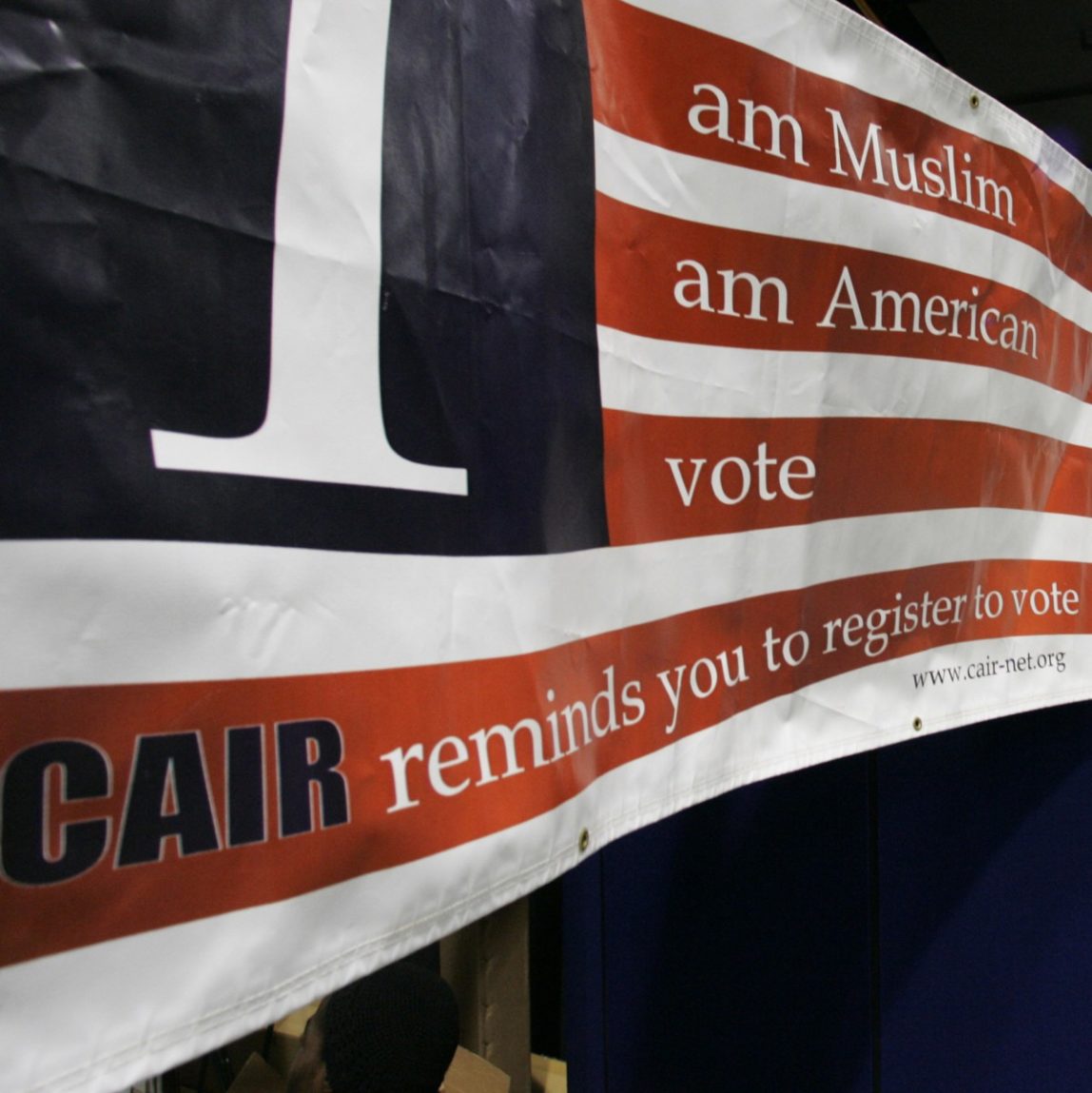 A sign in the bazaar at the 43rd annual ISNA convention encourages participants to register to vote Friday, Sept, 1, 2006 in Rosemont, Ill. (AP Photo/M. Spencer Green)