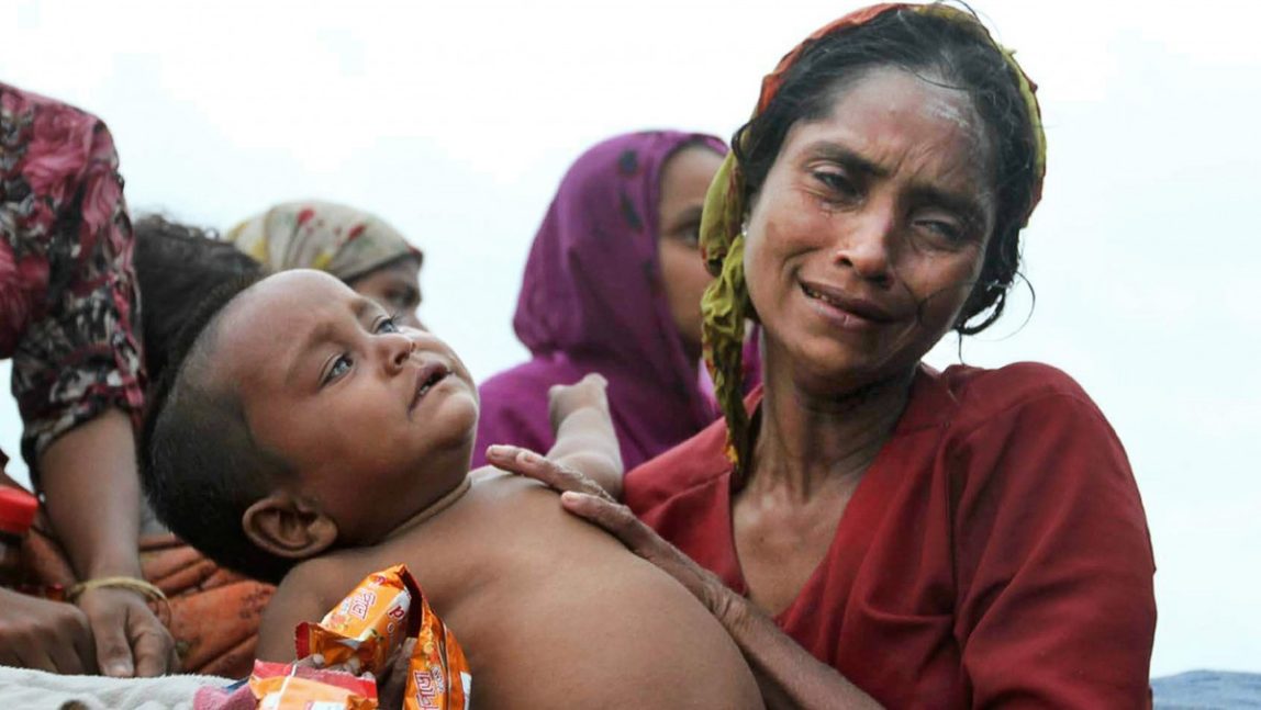 A Rohingya Muslim woman who fled Myanmar to Bangladesh to escape religious violence, sits with her baby in a boat after being intercepted crossing the Naf River by Bangladesh border authorities in Taknaf, Bangladesh, Wednesday, June 13, 2012. (AP Photo/Anurup Titu)