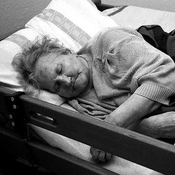 A woman sleeps in a bed at a nursing home on Nov. 7, 2009. (Photo by Ulrich Joho via Flikr)