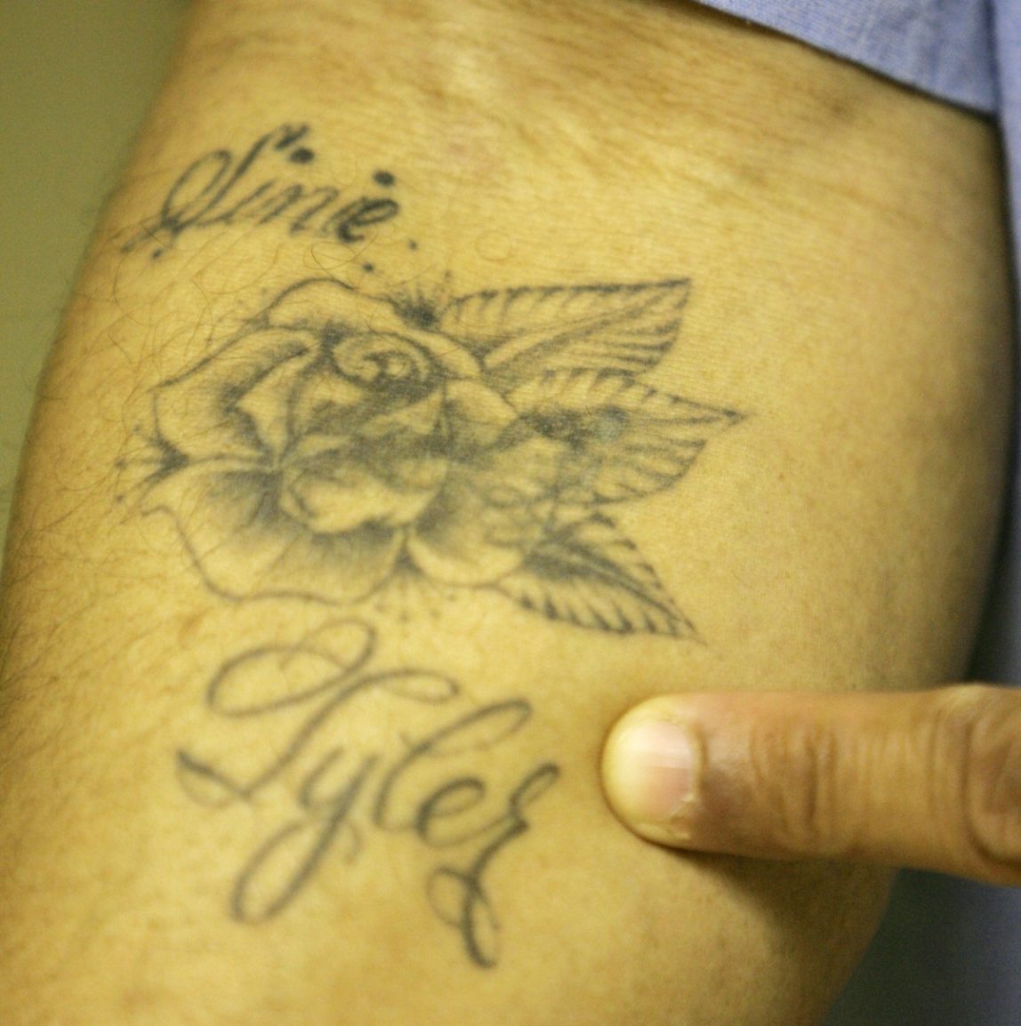 Inmate Anthony Harris points to his prison tattoo at the California Medical Facility in Vacaville, Calif., Jan. 17, 2007. Harris believes he contracted the Hepatitis C virus after getting the tattoo in 1998. (AP Photo/Marcio Jose Sanchez)