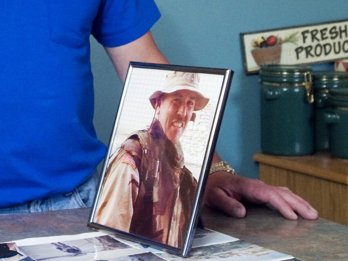 In this May 18, 2009 photo, Steve Moore recalls his brother, David, through photographs at home in Dubois, Ind. Sgt. David Moore died last year of a lung disorder after serving in the National Guard in Iraq where his brother believes he was exposed to a deadly chemical. (AP Photo/Brian Bohannon)