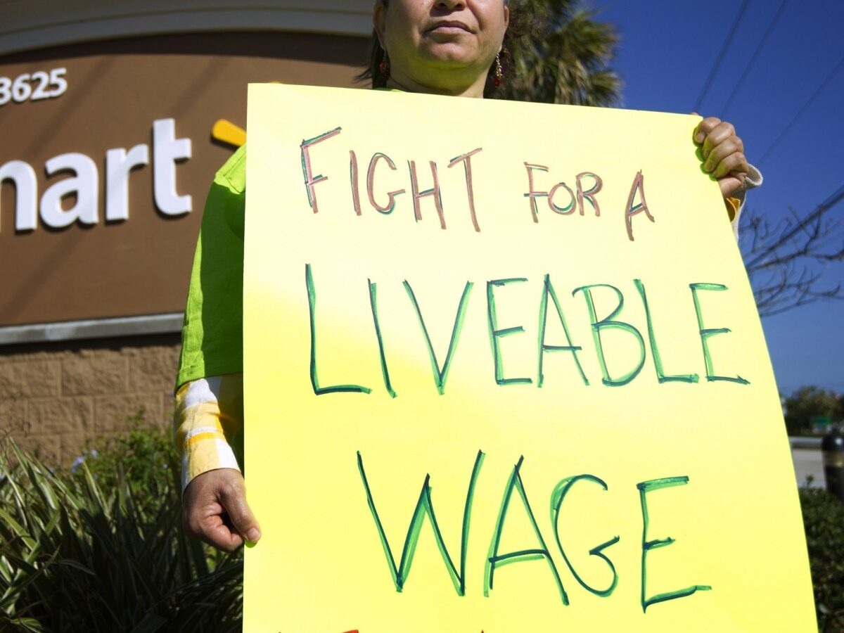 Nawal Elmilliax joins the protest against Wal-Mart in Boynton Beach, Fla., Friday, Nov 23, 2012. (AP Photo/J Pat Carter)