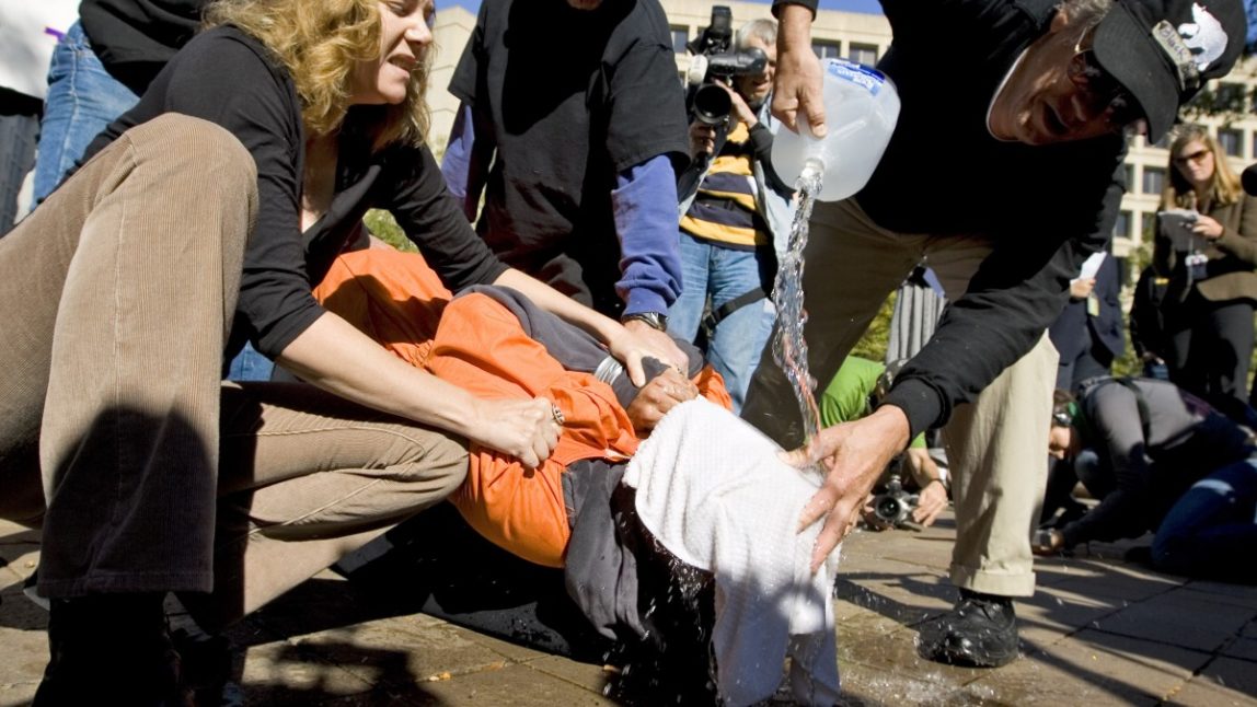 Protestors demonstrate the use of water boarding to volunteer Maboud Ebrahim Zadeh, Monday, Nov. 5, 2007, in front of the Justice Department in Washington. (AP Photo/Manuel Balce Ceneta)