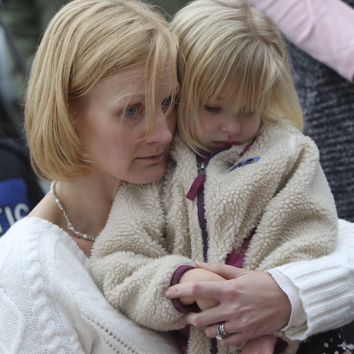 Barbara Wells of Shelton, Conn., holds her daughter Olivia, 3, as she pays her respects Monday, Dec. 17, 2012 at one of the makeshift memorials for the victims of the Sandy Hook Elementary School shooting in Newtown, Conn. (AP Photo/Mary Altaffer)