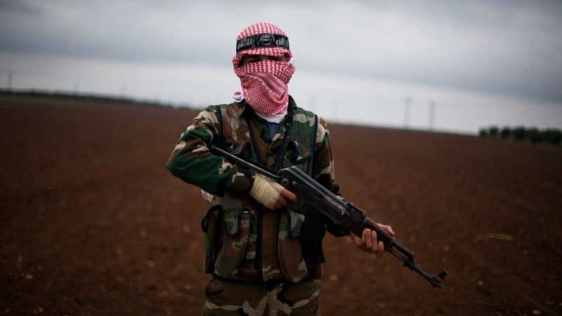 A Free Syrian Army fighter takes position close to a military base, near Azaz, Syria, Monday, Dec. 10, 2012. (AP Photo/Manu Brabo)