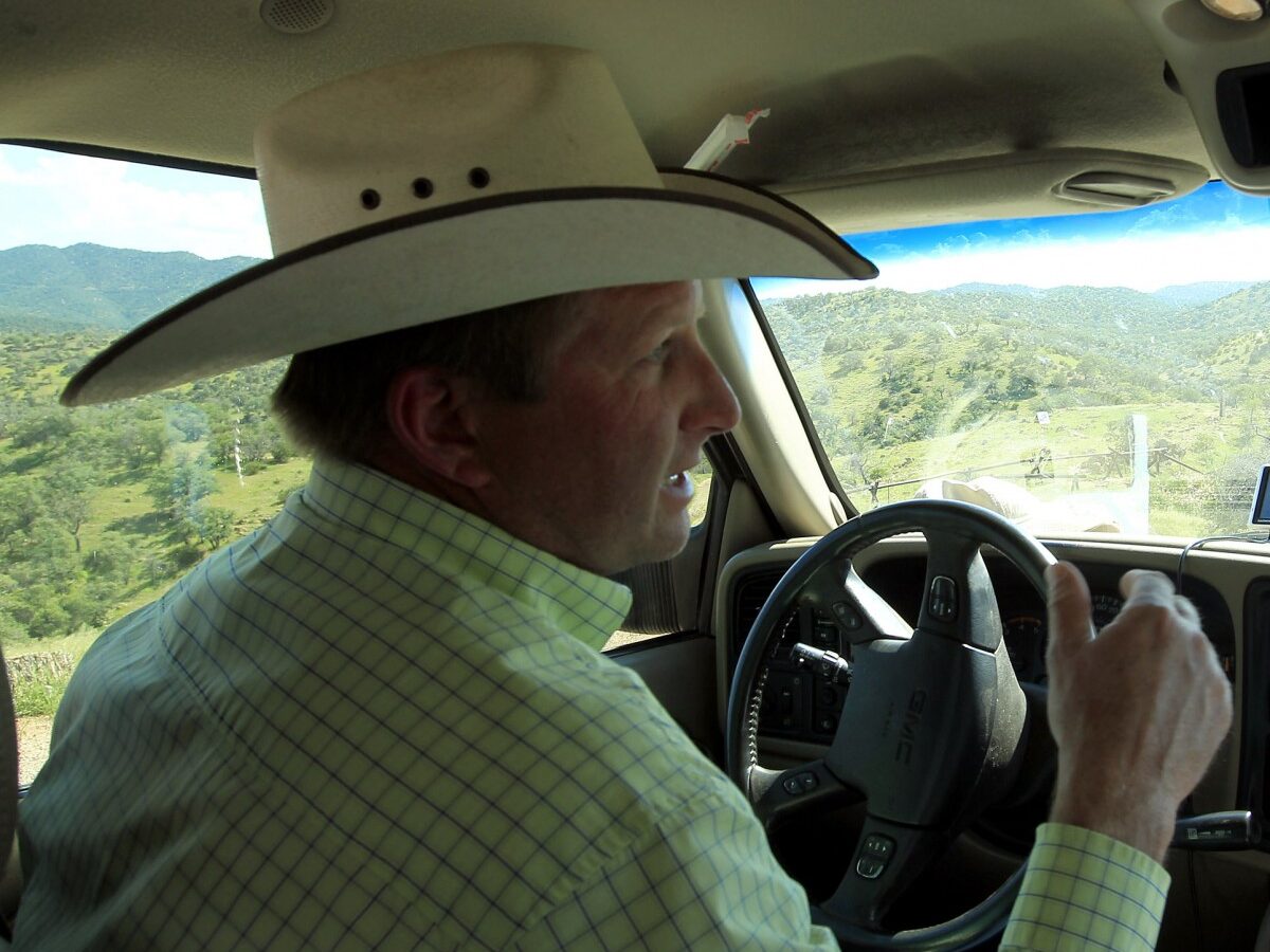 In this Friday, Aug. 10, 2012 photo, rancher Dan Bell, who leases a 35,000-acre cattle ranch along the border between the United States and Mexico, drives around as he checks out part of the property, in Nogales, Ariz. (AP Photo/Ross D. Franklin)
