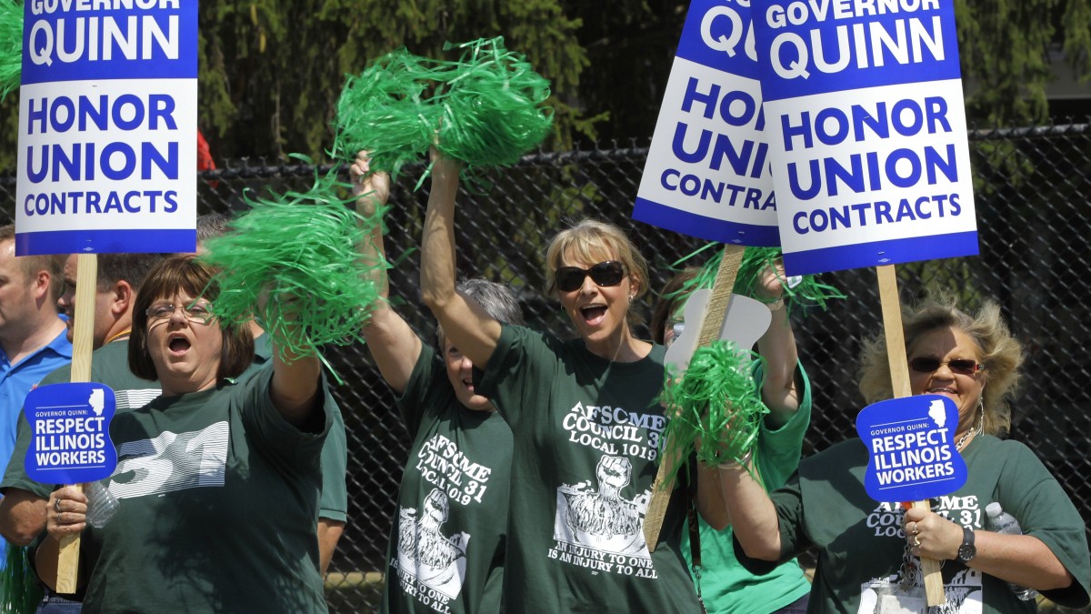 In this file photo taken Aug. 15, 2012 in Springfield, Ill., union members, supporters and labor leaders protest Illinois Gov. Pat Quinn. (AP Photo/Seth Perlman, File)