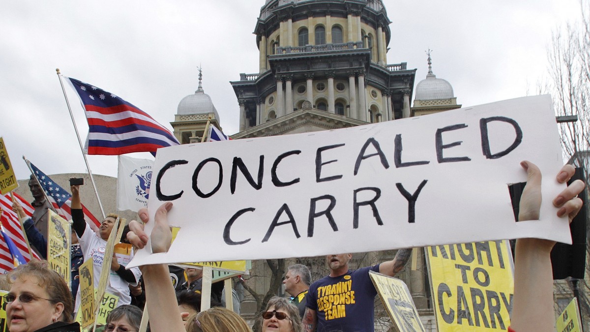 In this March 7, 2012 file photo, gun owners and supporters participate in an Illinois Gun Owners Lobby Day rally at the Illinois State Capitol in Springfield. (AP Photo/Seth Perlman, File)