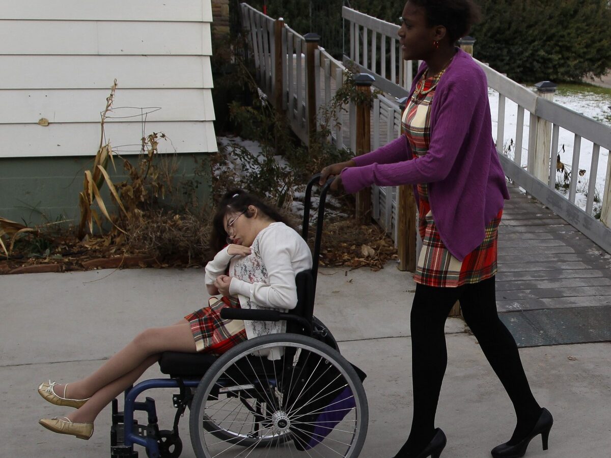 In this Nov. 14, 2012 photo, three of the four disabled adopted children of Carrie Ann Lucas, who is also disabled, prepare to leave their home in Windsor, Colo. on a car outing. From left are Heather, 22, Asiza, 17, and Anthony, 11. (AP Photo/Brennan Linsley)