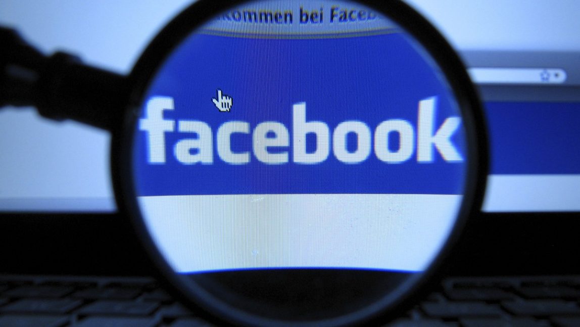 In this Oct. 10, 2011 file photo, a magnifying glass is posed over a monitor displaying a Facebook page in Munich. (AP Photo, Joerg Koch, File)