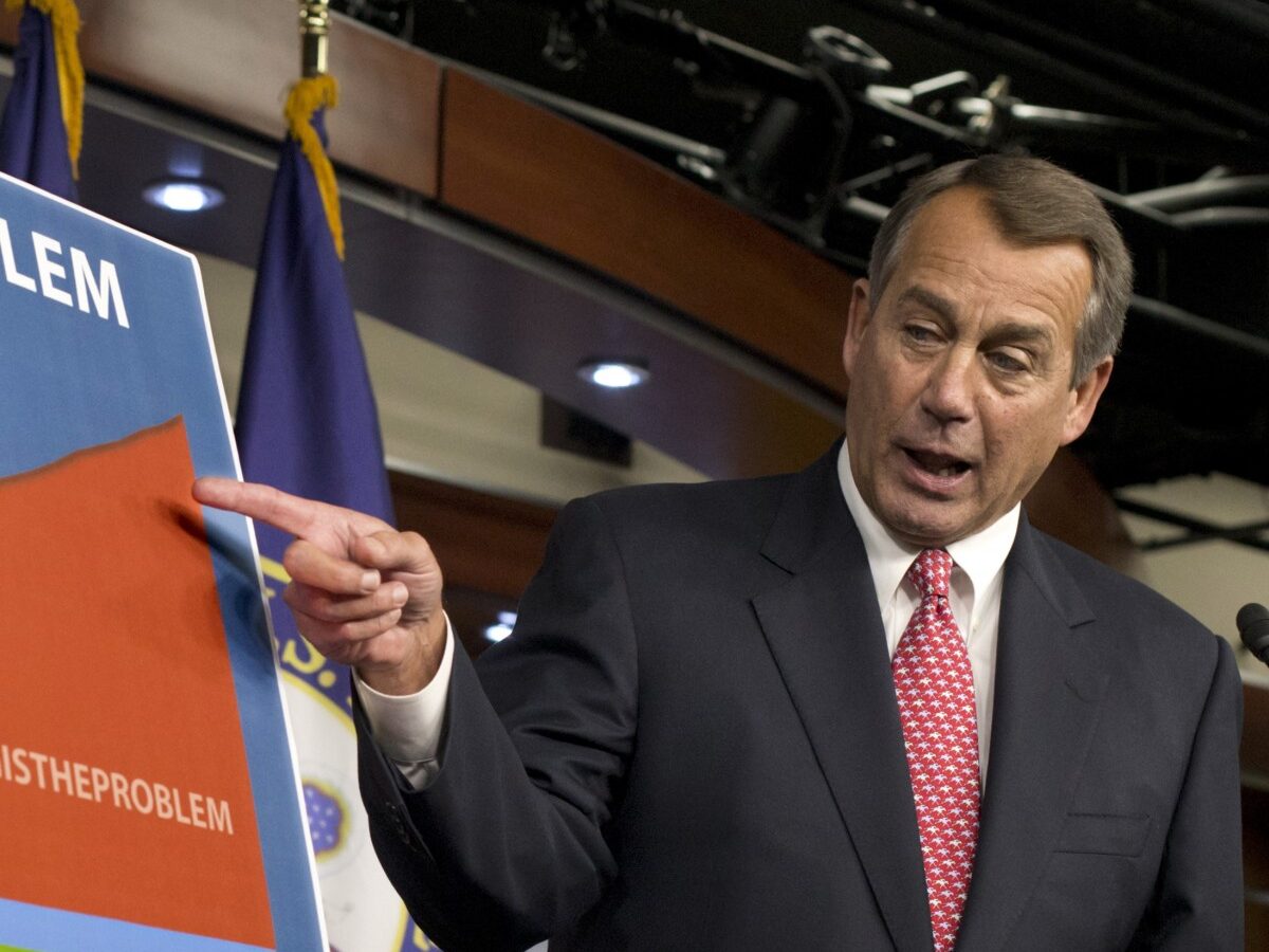 House Speaker John Boehner of Ohio points to a chart to emphasize his talking point that government spending complicates the negotiations on avoiding the so-called "fiscal cliff," during a news conference on Capitol Hill in Washington, Thursday, Dec. 13, 2012. (AP Photo/J. Scott Applewhite)