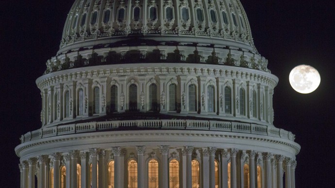 The moon rises behind the U.S. Capitol Dome in Washington as Congress works into the late evening, Sunday, Dec. 30, 2012 to resolve the stalemate over the pending "fiscal cliff." (AP Photo/J. David Ake)