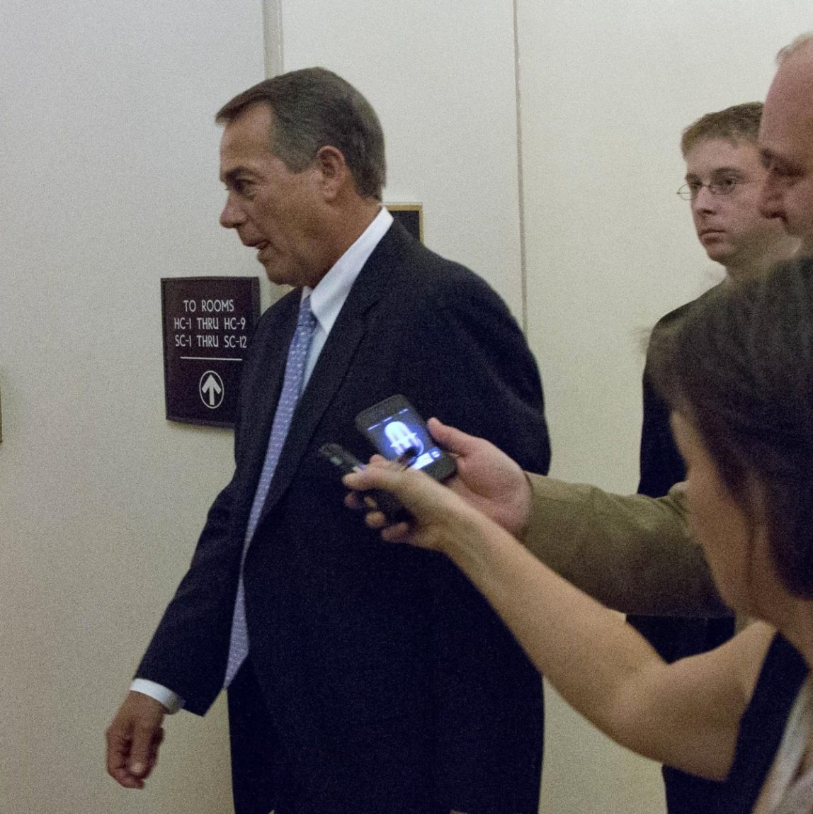 Speaker John Boehner of Ohio, center, departs, with reporters nearby after a House Republicans meeting on Capitol Hill, Thursday, Dec. 20, 2012 in Washington. (AP Photo/Alex Brandon)