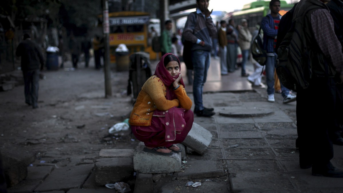 An Indian woman watches a candlelight vigil outside the hospital, where the recent rape victim is being treated, in New Delhi, India, Thursday, Dec. 20, 2012. (AP Photo/Altaf Qadri)
