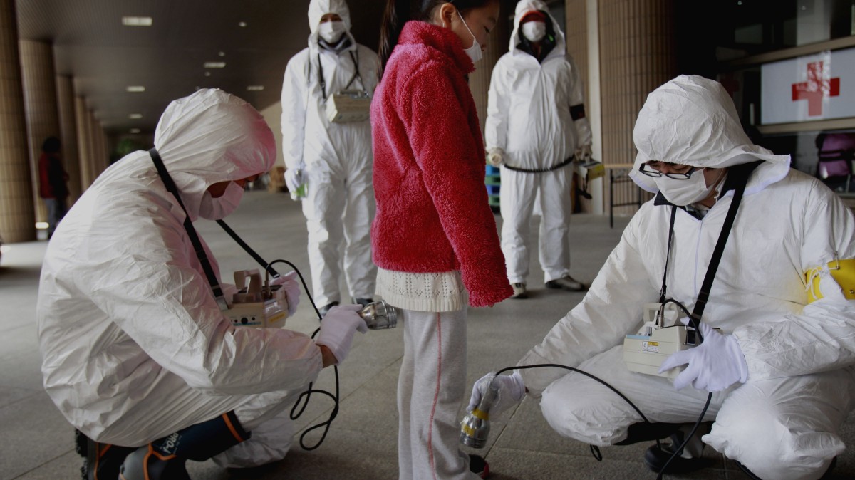 A young evacuee is screened at a shelter for leaked radiation from the damaged Fukushima nuclear plant, Thursday, March 24, 2011 in Fukushima, Fukushima prefecture, Japan. (AP Photo/Wally Santana)