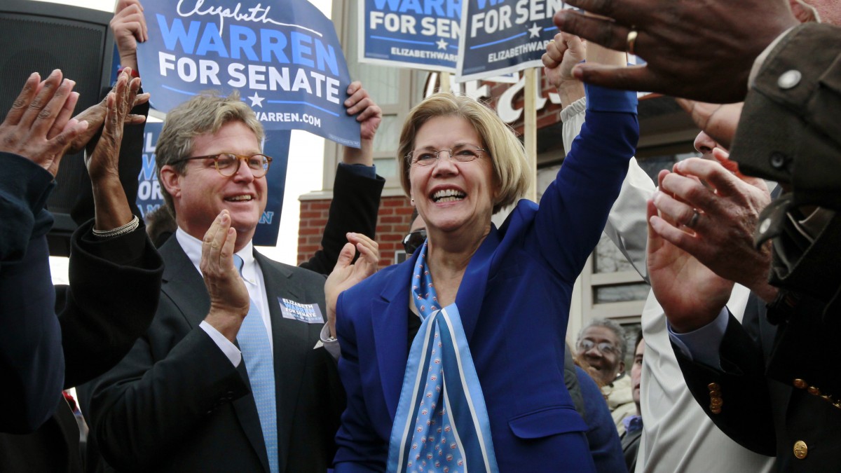 Democratic candidate for the U.S. Senate Elizabeth Warren, center, waves to the crowd as Edward M. Kennedy, Jr., left, son of the late U.S. Sen. Edward M. Kennedy, D-Mass., applauds during a campaign stop in the Dorchester neighborhood of Boston, Monday, Nov. 5, 2012. (AP Photo/Steven Senne)