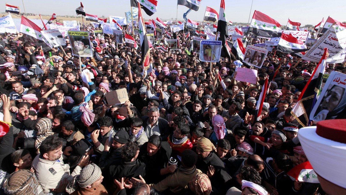 Protesters chant slogans against Iraq's Shiite-led government as they wave national flags during a demonstration in Ramadi, 70 miles (115 kilometers) west of Baghdad, Iraq, Wednesday, Dec. 26, 2012. (AP Photo/ Hadi Mizban)