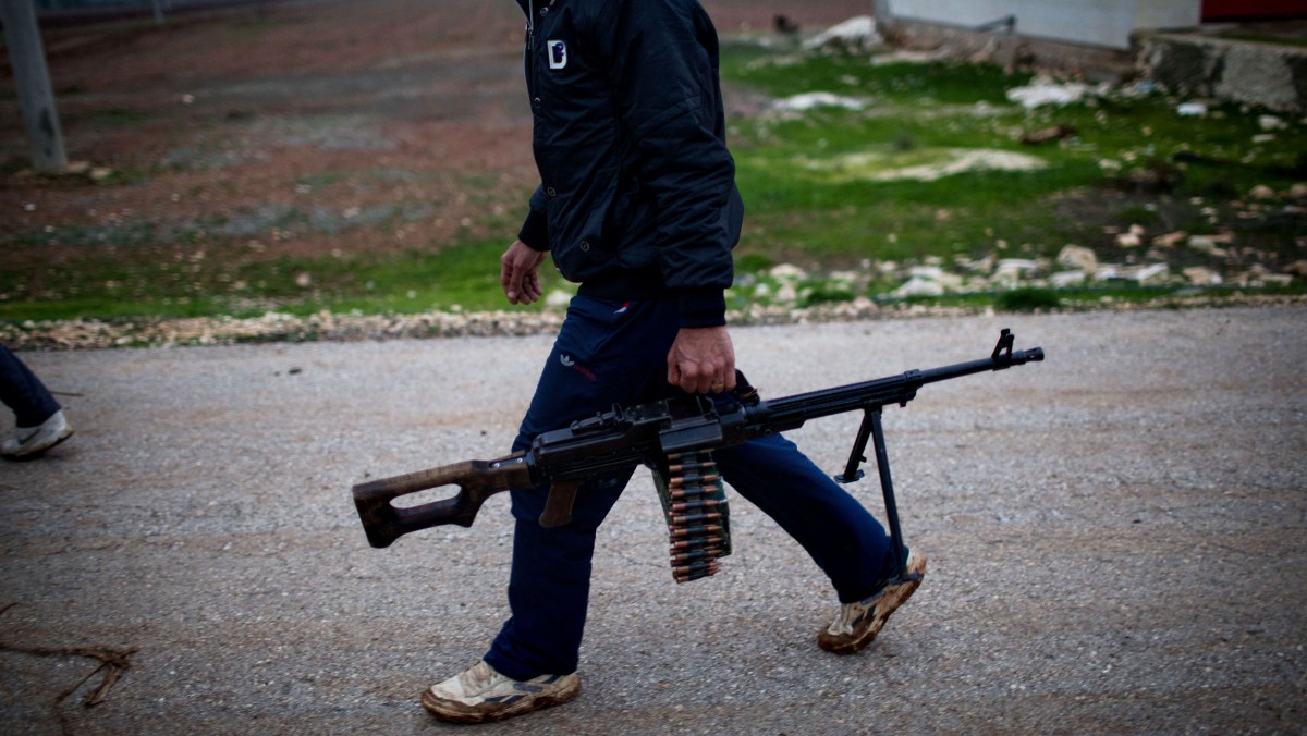 A Free Syrian Army fighter holds his weapon as he prepares himself for advance, close to a military base, near Azaz, Syria, Monday, Dec. 10, 2012. The gains by rebel forces came as the European Union denounced the Syrian conflict, which activists said had killed more than 40,000 people. (AP Photo/Manu Brabo)