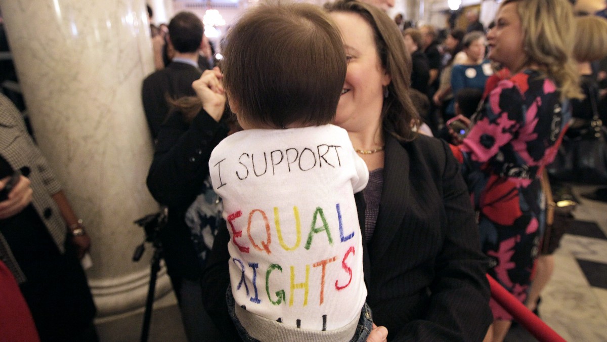 In this March 1, 2012 file photo, Rep. Anne Kaiser, D-Montgomery, an openly gay member of the Maryland General Assembly, holds Natalie Vincent, 10 months, the daughter of a member of Maryland Gov. Martin O'Malley's staff, after O'Malley signed the Civil Marriage Protection Act in Annapolis, Md. (AP Photo/Patrick Semansky, File)