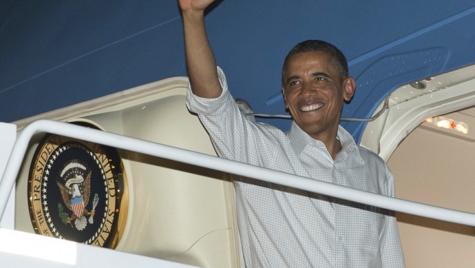 President Barack Obama boards Air Force One at Honolulu Joint Base Pearl Harbor-Hickam, Wednesday, Dec. 26, 2012, in Honolulu, en route to Washington. (AP Photo/Carolyn Kaster)