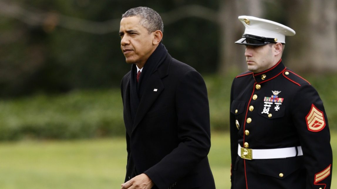 President Barack Obama walks past a Marine honor guard as he steps off the Marine One helicopter and walks on the South Lawn at the White House in Washington, Thursday, Dec. 27, 2012, as he returned early from his Hawaii vacation for meetings on the fiscal cliff. (AP Photo/Charles Dharapak)