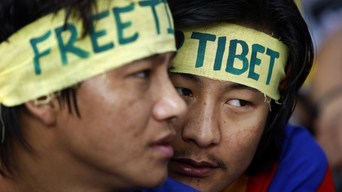 Exiled Tibetans wear headbands during a rally to mark World Human Rights Day in New Delhi, Monday, Dec. 10, 2012. At least 86 people have set themselves on fire since 2009. (AP Photo/Tsering Topgyal)