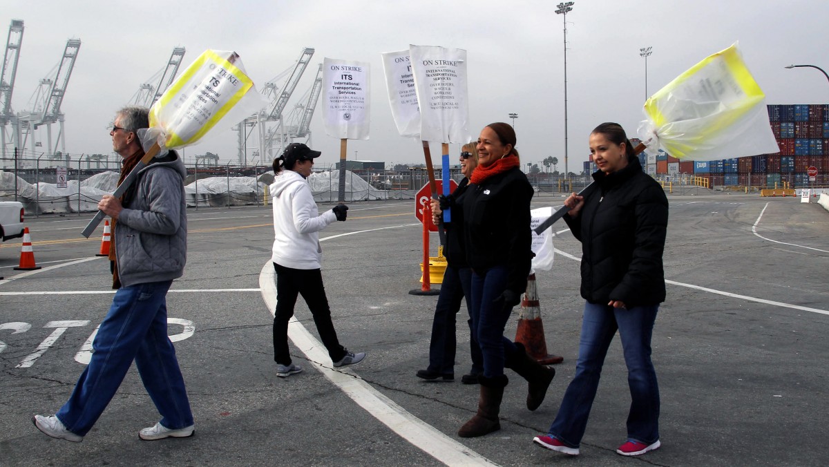 Clerical workers carry signs in protest at the Port of Long Beach, Calif. on Tuesday, December 4, 2012. (AP Photo/Nick Ut)