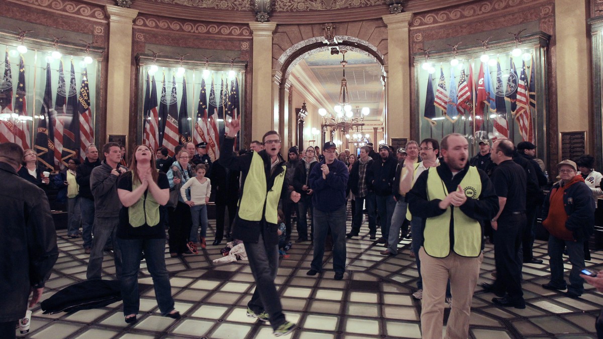 Union workers chant in the lower level of the Capitol rotunda in Lansing, Mich., Thursday, Dec. 6, 2012. (AP Photo/Carlos Osorio)