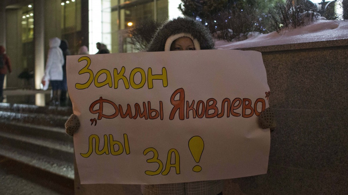 A demonstrator holds a poster outside the Federation Council on Wednesday, Dec. 26, 2012. (AP Photo/Alexander Zemlianichenko)