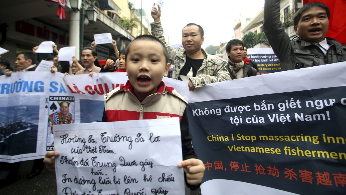 Vietnamese protesters march down the streets in a protest demanding China to stay out of their waters following China's increased activities around the Spratly, Paracel Islands and other disputed areas, in Hanoi, Vietnam on Sunday, Dec. 9 , 2012. (AP Photo/Na Son Nguyen).