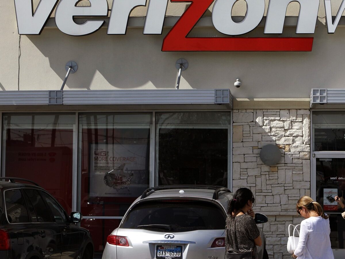 In this Wednesday, Oct. 17, 2012, file photo, customers walk into a Verizon Wireless store in Dallas. (AP Photo/LM Otero, File)