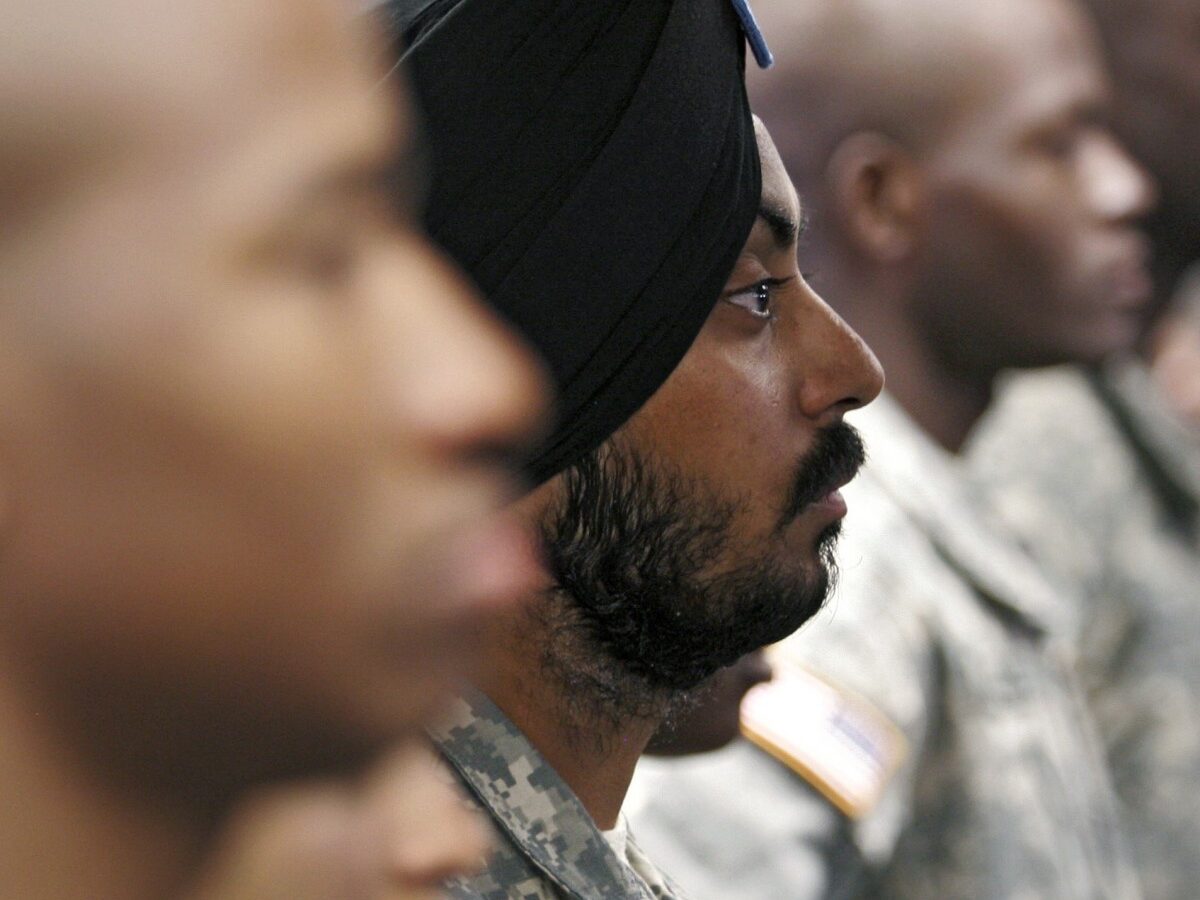 U.S. Army Spc. Simran Lamba, center, the first enlisted Soldier to be granted a religious accommodation for his Sikh articles of faith since 1984, stands in formation with fellow soldiers before taking the oath of citizenship, prior to his graduation from basic training at Fort Jackson, S.C., Wednesday, Nov. 10, 2010. (AP Photo/Brett Flashnick)