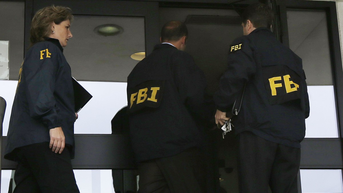 FBI agents enter Trenton City Hall, Thursday, July 19, 2012, in Trenton, N.J. (AP Photo/Julio Cortez)