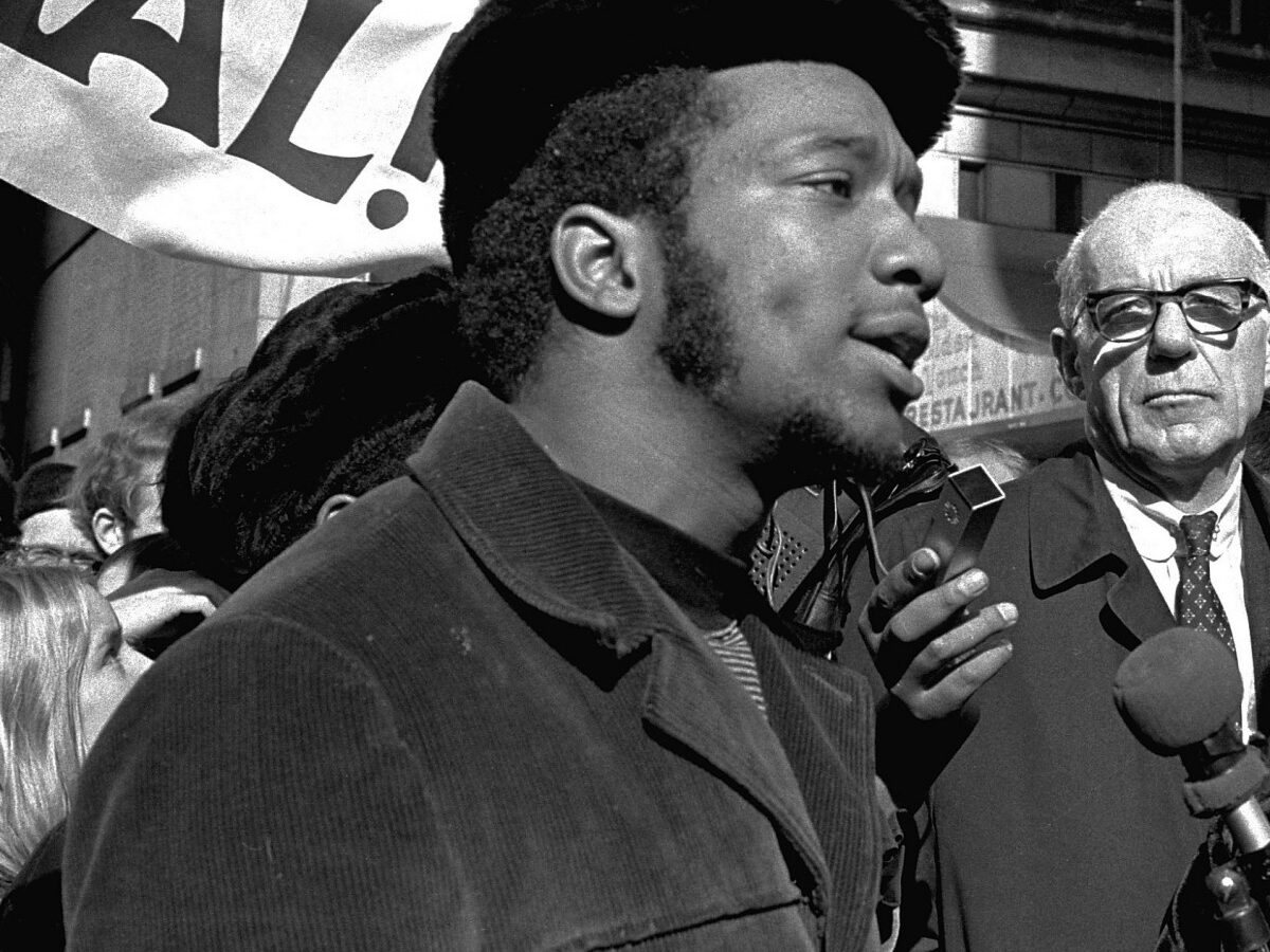 At a rally outside the U.S. Courthouse October 29, 1969, Dr. Benjamin Spock, background, listens to Fred Hampton, chairman of the Illinois Black Panther party. (AP Photo/stf)