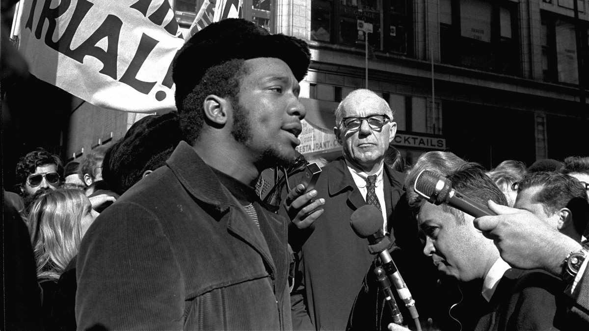 At a rally outside the U.S. Courthouse October 29, 1969, Dr. Benjamin Spock, background, listens to Fred Hampton, chairman of the Illinois Black Panther party. (AP Photo/stf)